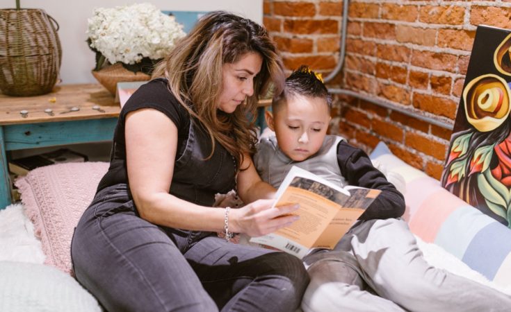 mother reading book with her son